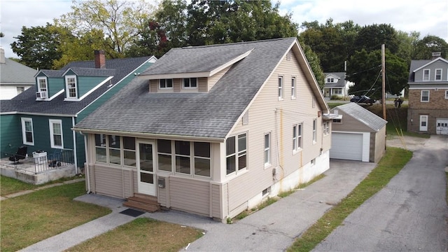 view of front facade with an outbuilding, a front lawn, and a garage