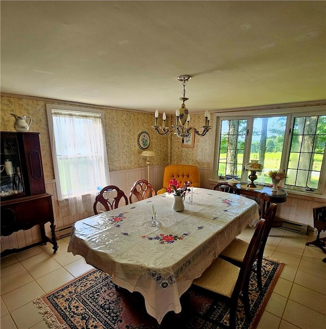 tiled dining room with a chandelier