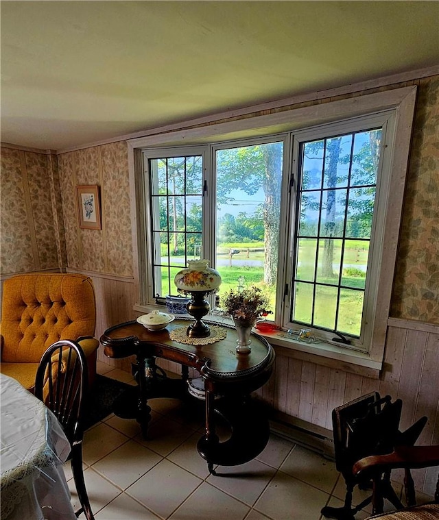 dining room with wood walls and light tile patterned floors