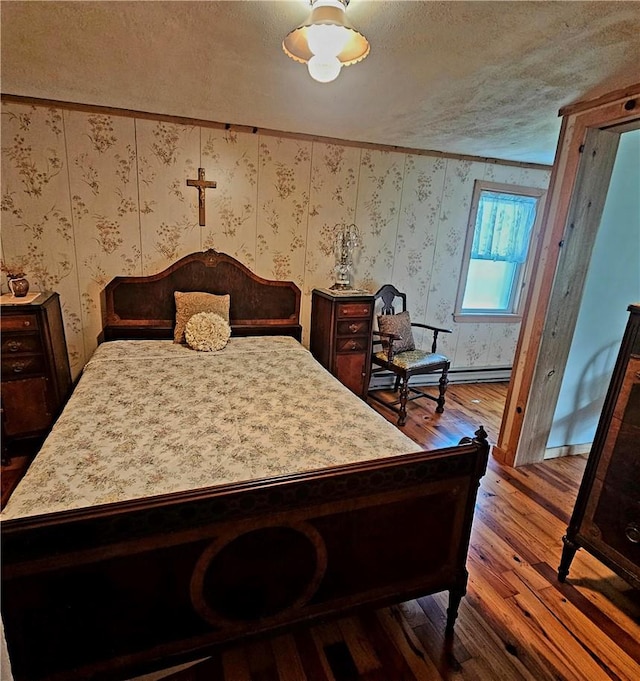 bedroom featuring hardwood / wood-style flooring and a textured ceiling