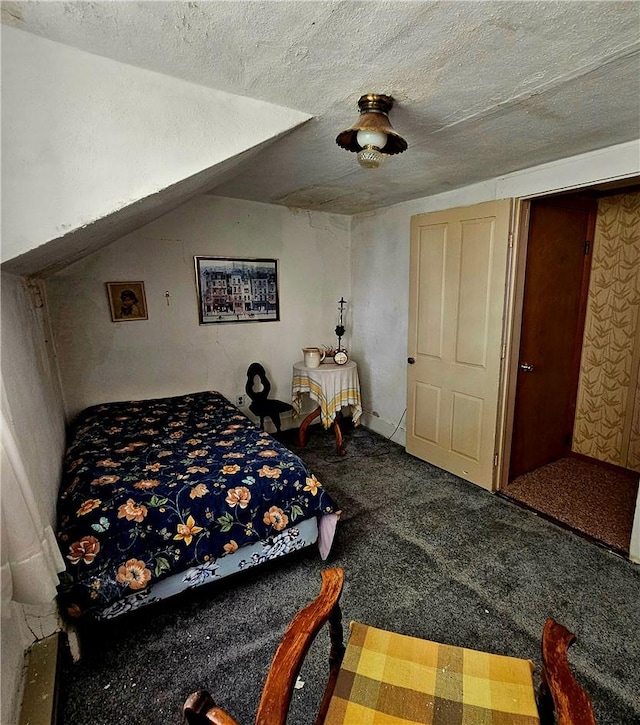 carpeted bedroom with a textured ceiling, ceiling fan, and vaulted ceiling