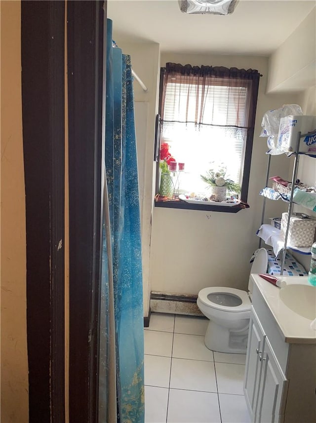 bathroom with tile patterned flooring, vanity, and toilet