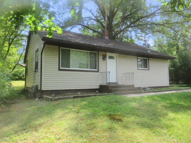 ranch-style home with a front lawn