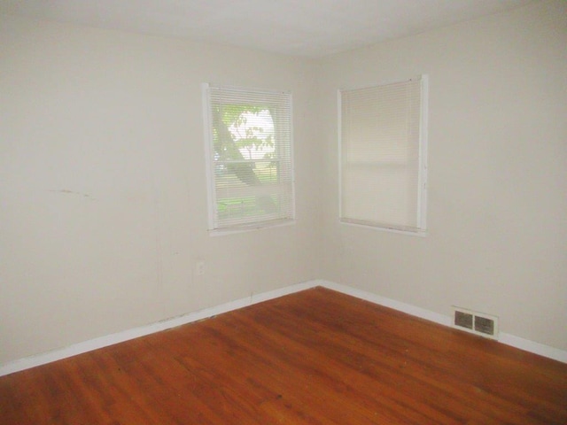 spare room with hardwood / wood-style floors