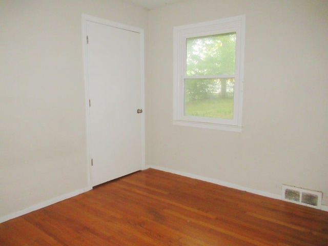 spare room featuring hardwood / wood-style floors