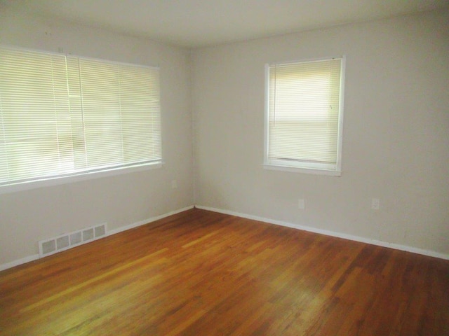 empty room featuring dark hardwood / wood-style flooring