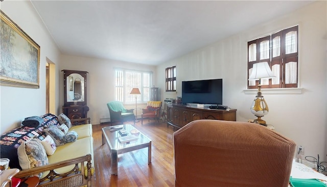 living room featuring hardwood / wood-style floors and a baseboard heating unit