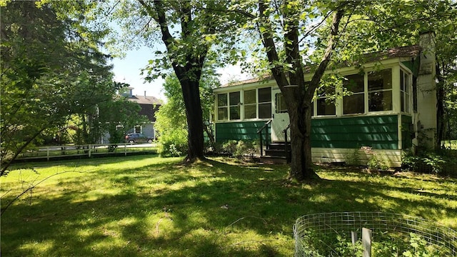 view of yard featuring a sunroom