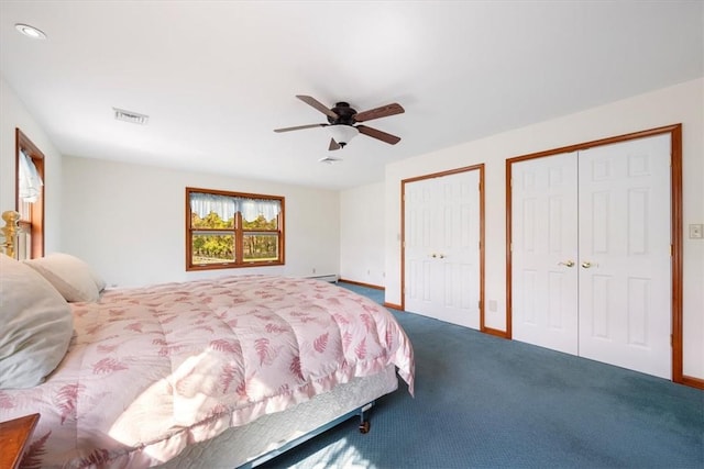 carpeted bedroom featuring multiple closets and ceiling fan