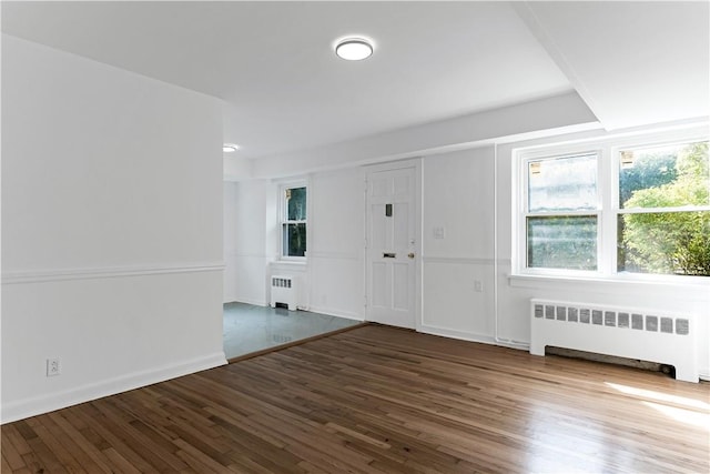 foyer featuring dark hardwood / wood-style flooring and radiator