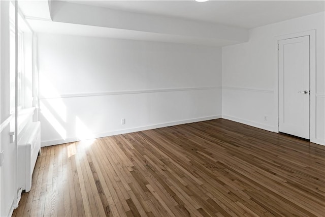 unfurnished room featuring dark wood-type flooring