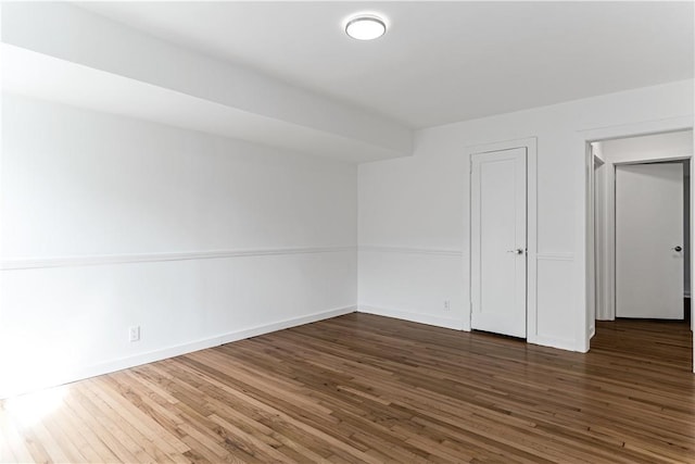 empty room featuring dark hardwood / wood-style flooring