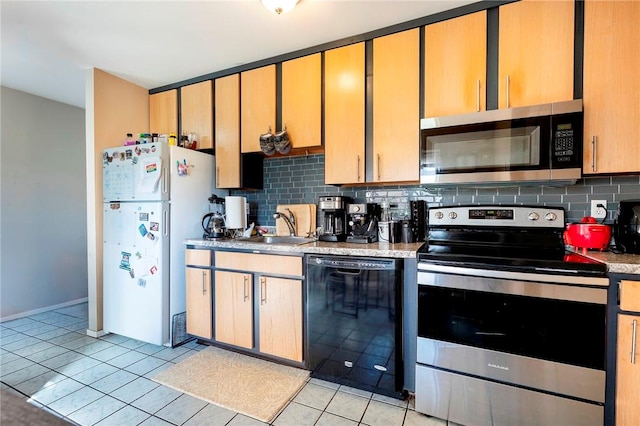 kitchen with sink, appliances with stainless steel finishes, backsplash, and light tile patterned flooring