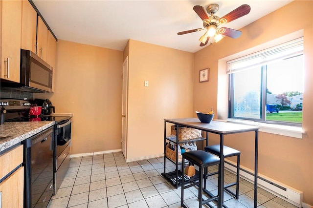 kitchen featuring tasteful backsplash, light brown cabinets, stainless steel appliances, and a baseboard heating unit