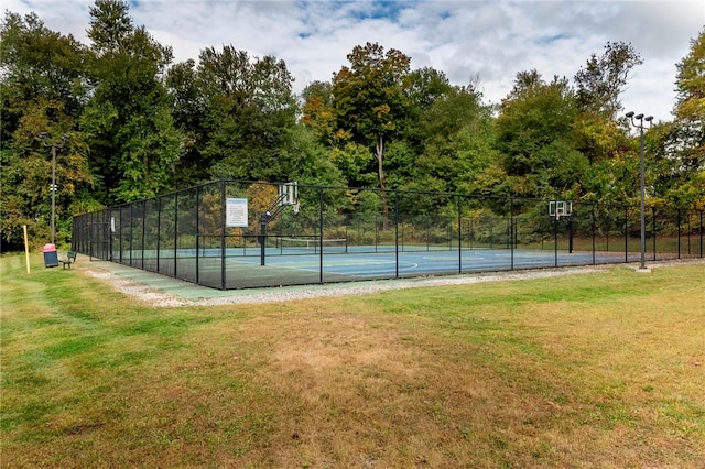 view of basketball court featuring tennis court and a yard