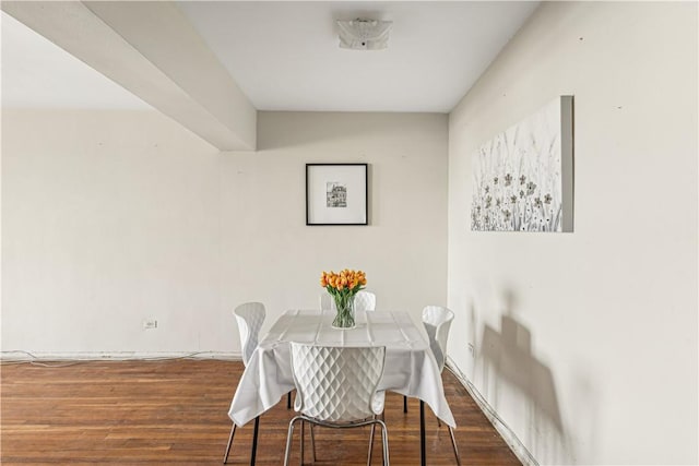 dining space with dark hardwood / wood-style flooring