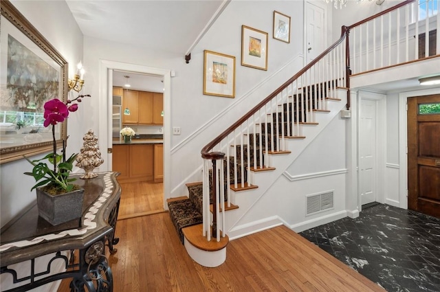 stairs featuring hardwood / wood-style flooring