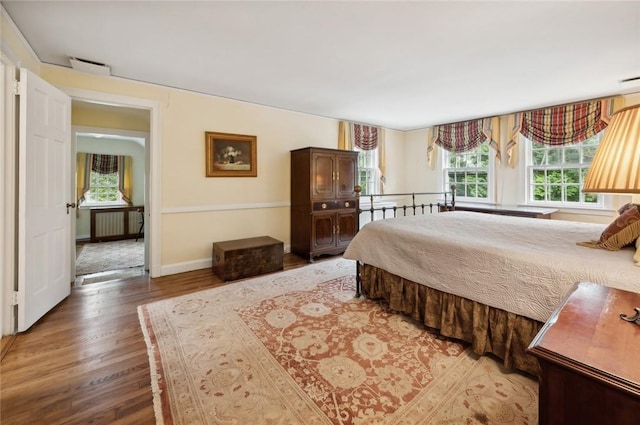 bedroom featuring wood-type flooring and radiator