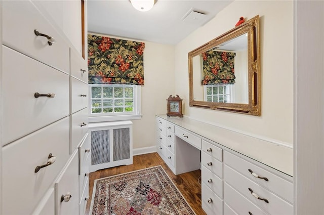 interior space with dark hardwood / wood-style floors and radiator