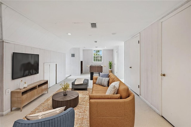 carpeted living room with lofted ceiling