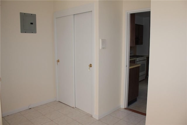 unfurnished bedroom with electric panel, a closet, and light tile patterned floors