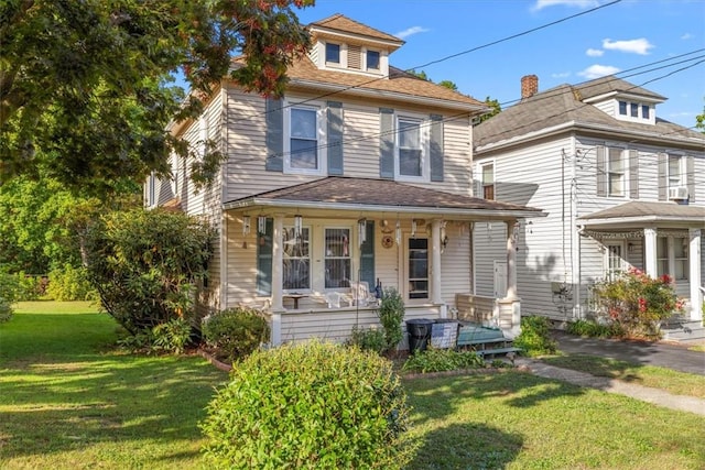 view of front of property featuring covered porch and a front yard