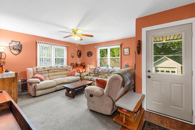 carpeted living room featuring ceiling fan and a healthy amount of sunlight