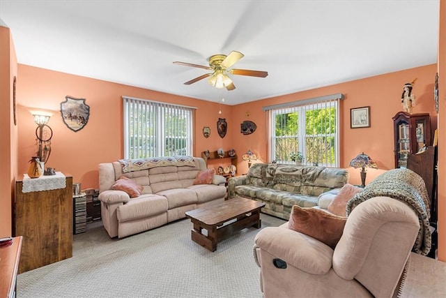 carpeted living room with ceiling fan