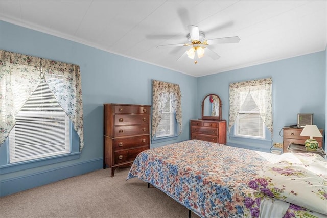 carpeted bedroom with ceiling fan and crown molding