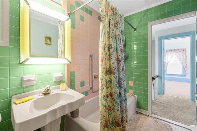 bathroom with backsplash, crown molding, sink, shower / bathtub combination with curtain, and tile walls