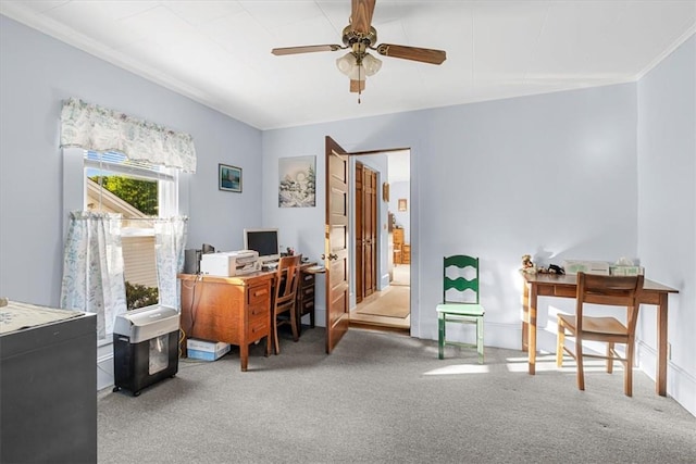 office area featuring ceiling fan, carpet floors, and crown molding