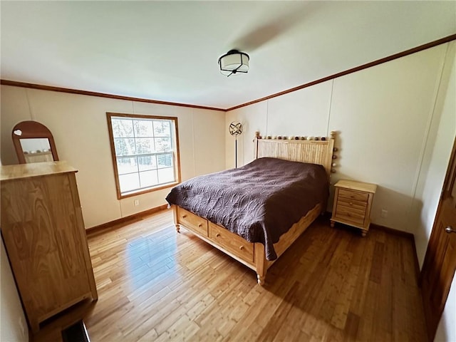 bedroom with hardwood / wood-style floors and ornamental molding