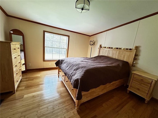 bedroom with hardwood / wood-style floors and ornamental molding