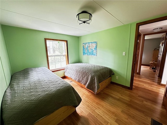 bedroom featuring wood-type flooring