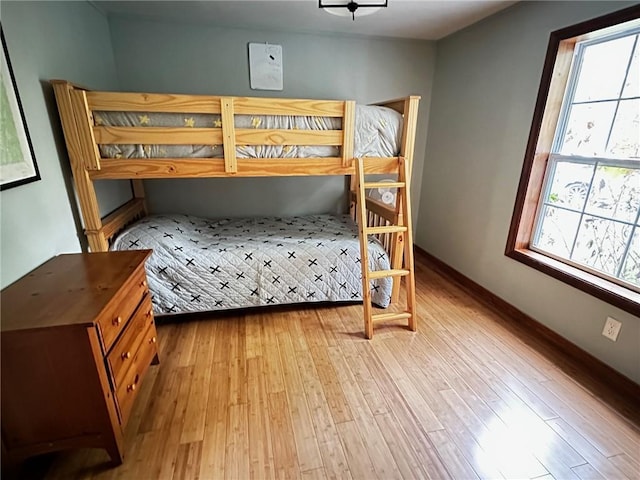 bedroom featuring multiple windows and light hardwood / wood-style floors