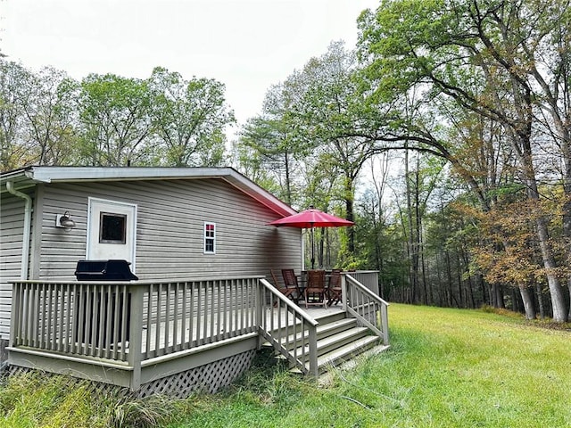 wooden terrace with a yard