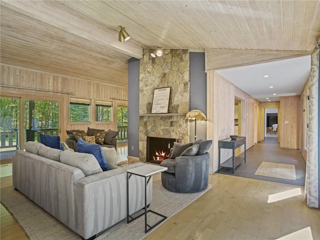 living room with a fireplace, wooden ceiling, lofted ceiling, and hardwood / wood-style flooring