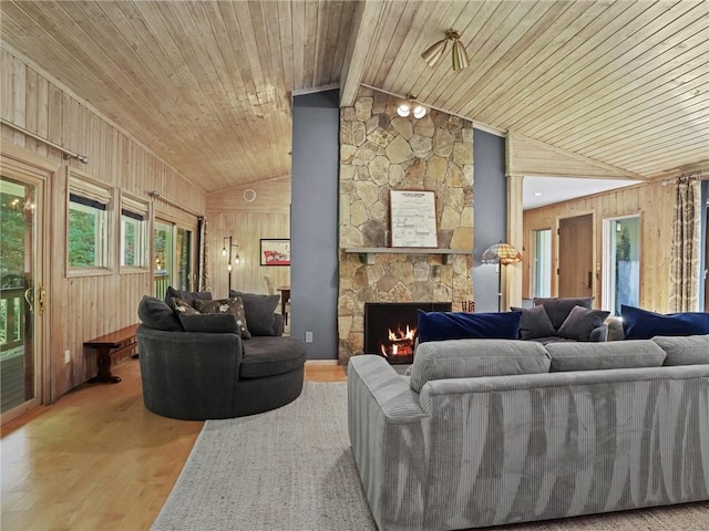 living room with wooden walls, light hardwood / wood-style flooring, lofted ceiling, and wood ceiling