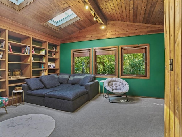 carpeted living room with track lighting, wooden ceiling, and vaulted ceiling with skylight