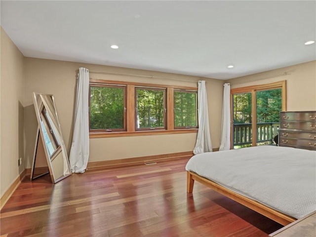 bedroom featuring access to outside and hardwood / wood-style floors