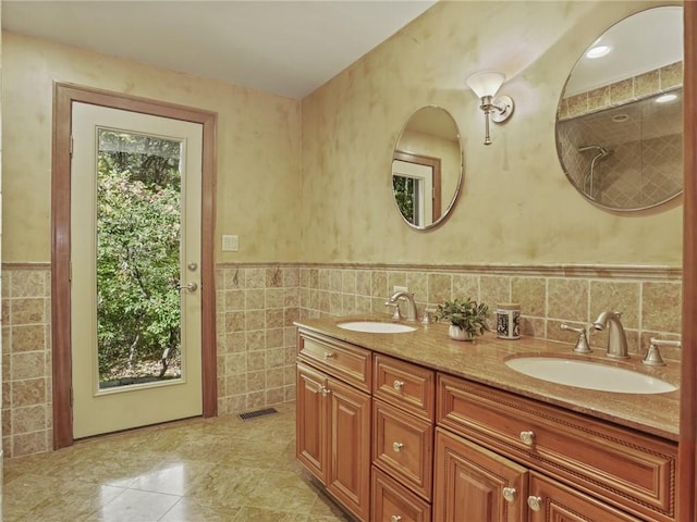 bathroom with vanity and tile walls