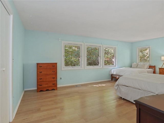 bedroom featuring light hardwood / wood-style floors and a closet