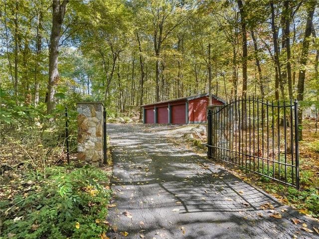 view of gate with an outbuilding