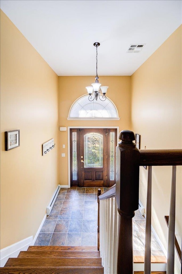 foyer featuring a chandelier and a baseboard radiator