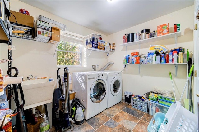 laundry area with independent washer and dryer and sink