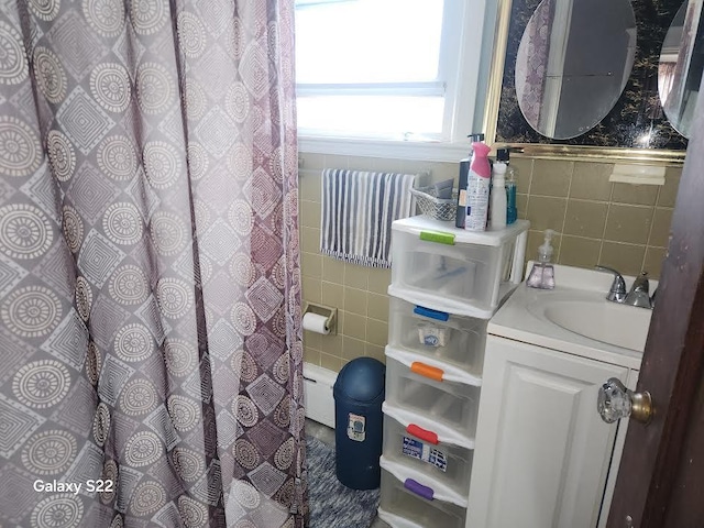 bathroom featuring vanity and tile walls