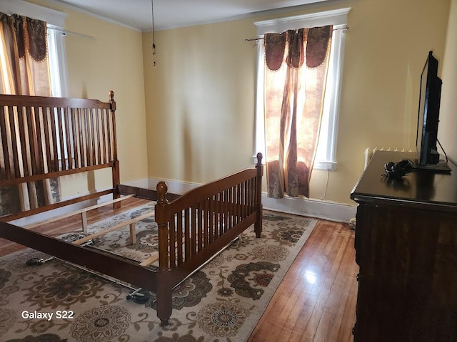 bedroom featuring light hardwood / wood-style floors and ornamental molding