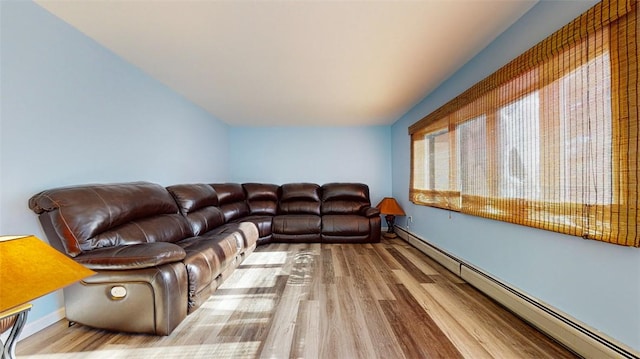 living room featuring wood-type flooring and baseboard heating