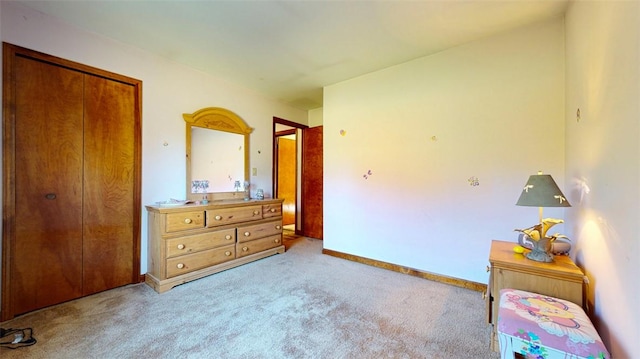 bedroom featuring light carpet and a closet