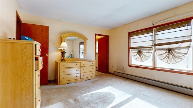 unfurnished bedroom with carpet and a baseboard radiator